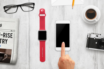 Poster - Smart watch and phone with isolated, blank screen for mockup. Top view of table with camera, coffee, glasses, newspaper.