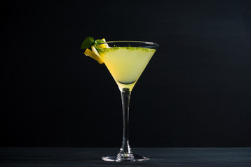 Wall Mural - Yellow martini cocktail with lemon and mint on the rustic wooden background