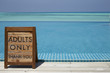 © Monkey Business - Adults only sign by an infinity pool with ocean beyond