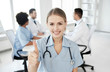 © Syda Productions - happy doctor over group of medics at hospital