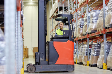 Wall Mural - man operating forklift loader at warehouse