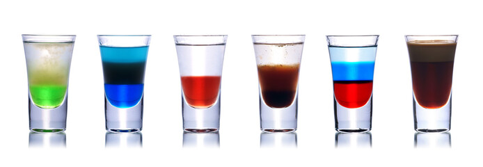 Set of colorful alcoholic cocktails in shot glasses isolated on white with reflection. Colletion of shooters