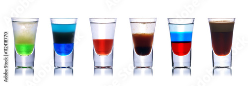 Fotografía Set of colorful alcoholic cocktails in shot glasses isolated on white with reflection