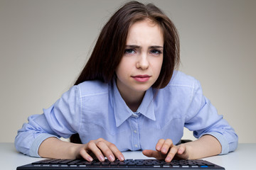 Wall Mural - Frowning woman using keypad