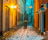 Fototapeta Uliczki - First snow in narrow medieval street in the old Riga city, Latvia