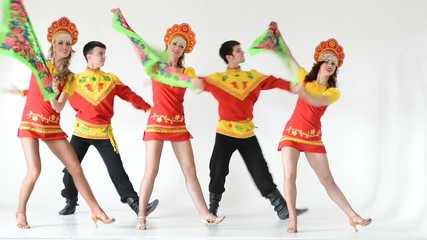 Wall Mural - Dancer team wearing a folk costumes isolated on white