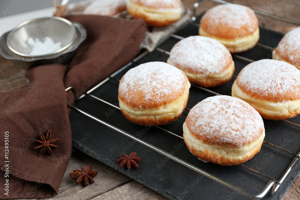 Fresh homemade donuts with powdered sugar, close up