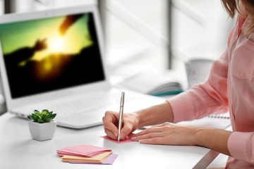 Canvas Print - Businesswoman writing with pen in office