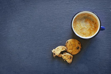 Mug of coffee with cookies on wooden table