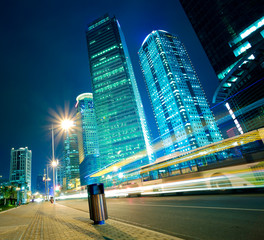 Wall Mural - Road light trails on streetscape office buildings in shanghai