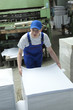 Stock offset paper.  Man working in print factory