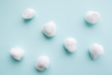 Cotton Balls On Blue Background Flat Lay. Several Cotton Balls For Dentist Manipulations. Close-up On Group Of Seven Cottonballs.