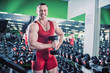 © de Art - man is engaged in fitness bodybuilder dumbbell raises