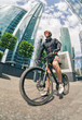 © Sergey Chumakov - young man cyclist stand with bicycle at street among skyscrapers
