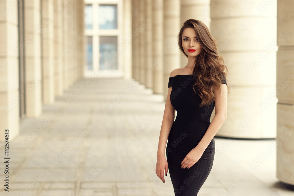 Young elegant girl posing at city street. Pretty beautiful business woman  in elegant black dress against city background. Stock Photo | Adobe Stock