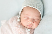 Beautiful Sleeping Newborn Baby In Hat And Wrapped Close-up