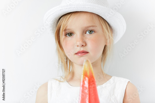 Quiet Little Girl With Blond Hair All In White Looking At Camera