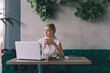 © cherryandbees - Work is pleasure, even on coffee break. Woman working on laptop  in cafe bar.