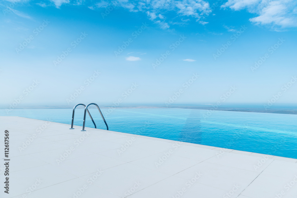Infinity pool on the bright summer day - obrazy, fototapety, plakaty 