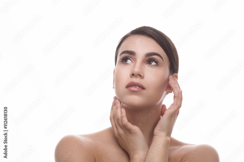 Closeup portrait of beautiful woman touching her face and looking away ...