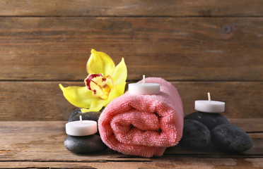 Poster - Spa still life with stones, flower and candlelight on wooden background