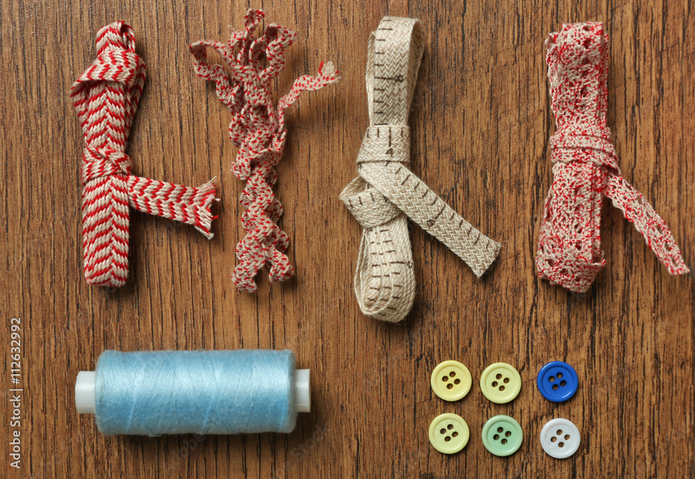 Sewing creative accessories on wooden table, top view