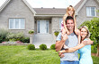 © grinny - Happy family near new house.