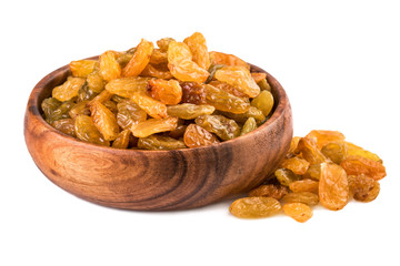 Wall Mural - Raisins in a wooden cup on white background. Closeup.