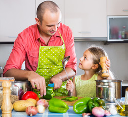 Dad and little daughter cooking