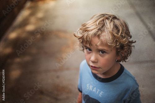 Poratrit Of Curly Haired Blonde Boy Looking At Camera Buy This