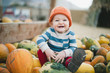 © Aria Bethards - Baby boy sitting on top of pumpkins, smiling