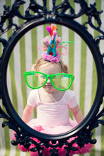 Young Girl At Birthday Party Wearing Oversized Glasses
