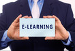 © Zsolt Biczó - Business man hold paper online training text on it