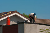 Fototapeta  - man repairing roof