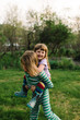 © Breanna Peterson - Young boy giving sister piggyback, outdoors