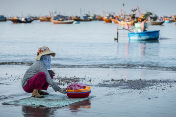 Woman sitting on the beach Mui Ne beach, Vietnam