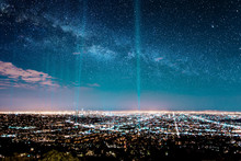 Beans of light in starry sky over los angeles