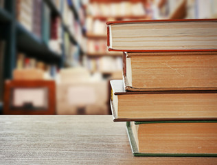 Poster - Books on desk in library. School concept