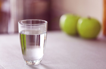 Wall Mural - Glass of pure water on kitchen table