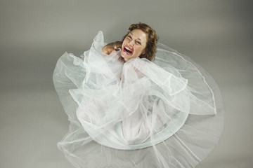 High angle beautiful young ballerina sit in the floor with a whi