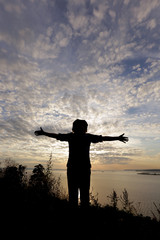 silhouette of a man on the river bank