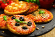 © gkrphoto - Mix of mini pizzas on a stone try