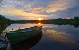 Fototapeta Pomosty - fisherman boat at sunset time