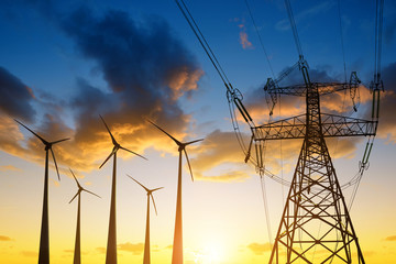 Wall Mural - high voltage tower and wind turbines against the sunset