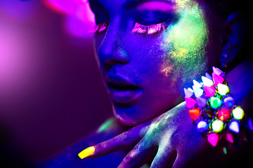 Wall Mural - Fashion model woman in neon light, portrait of beautiful model girl with fluorescent make-up
