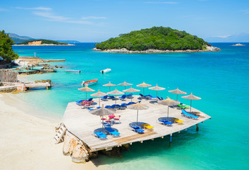 Sunshade umbrellas and  deckchairs  on the beautiful Ksamil beach, Albania.