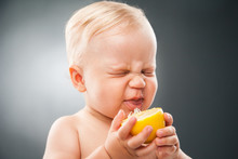 Baby Squinting Eyes While Licking Lemon