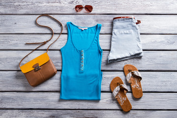 Wall Mural - Blue tank top and shorts. Footwear and buttoned tank top. New items from summer catalog. Time to dress up.