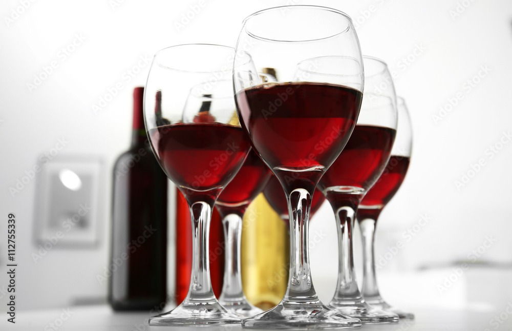 Glasses of red wine on white table closeup
