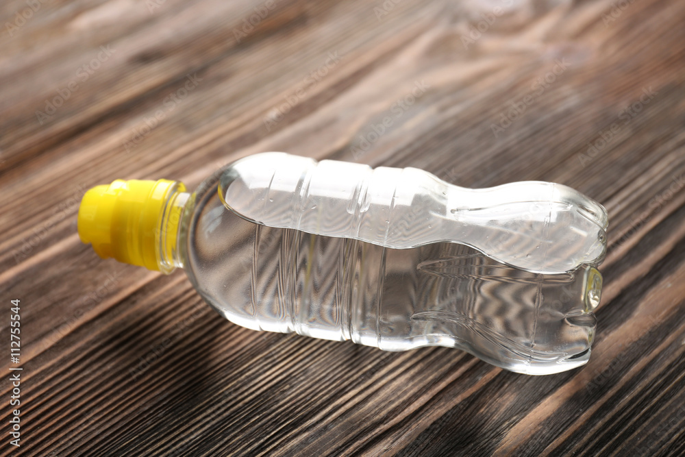 Bottled water on the wooden table, close up